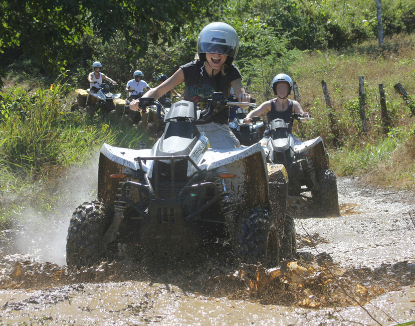 Guests riding ATVs through the mud in Ocho Rios