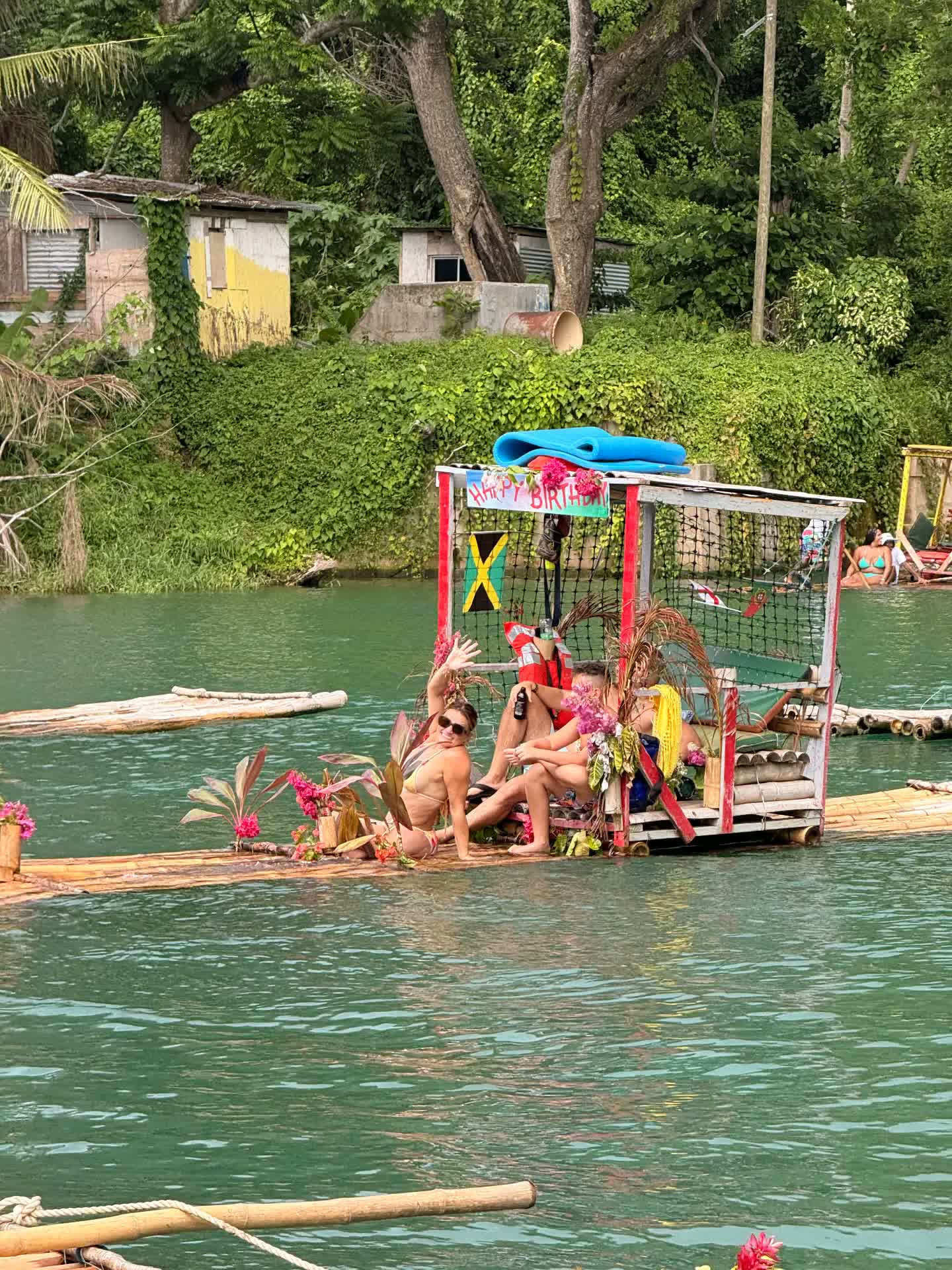 Guests waving from a river raft